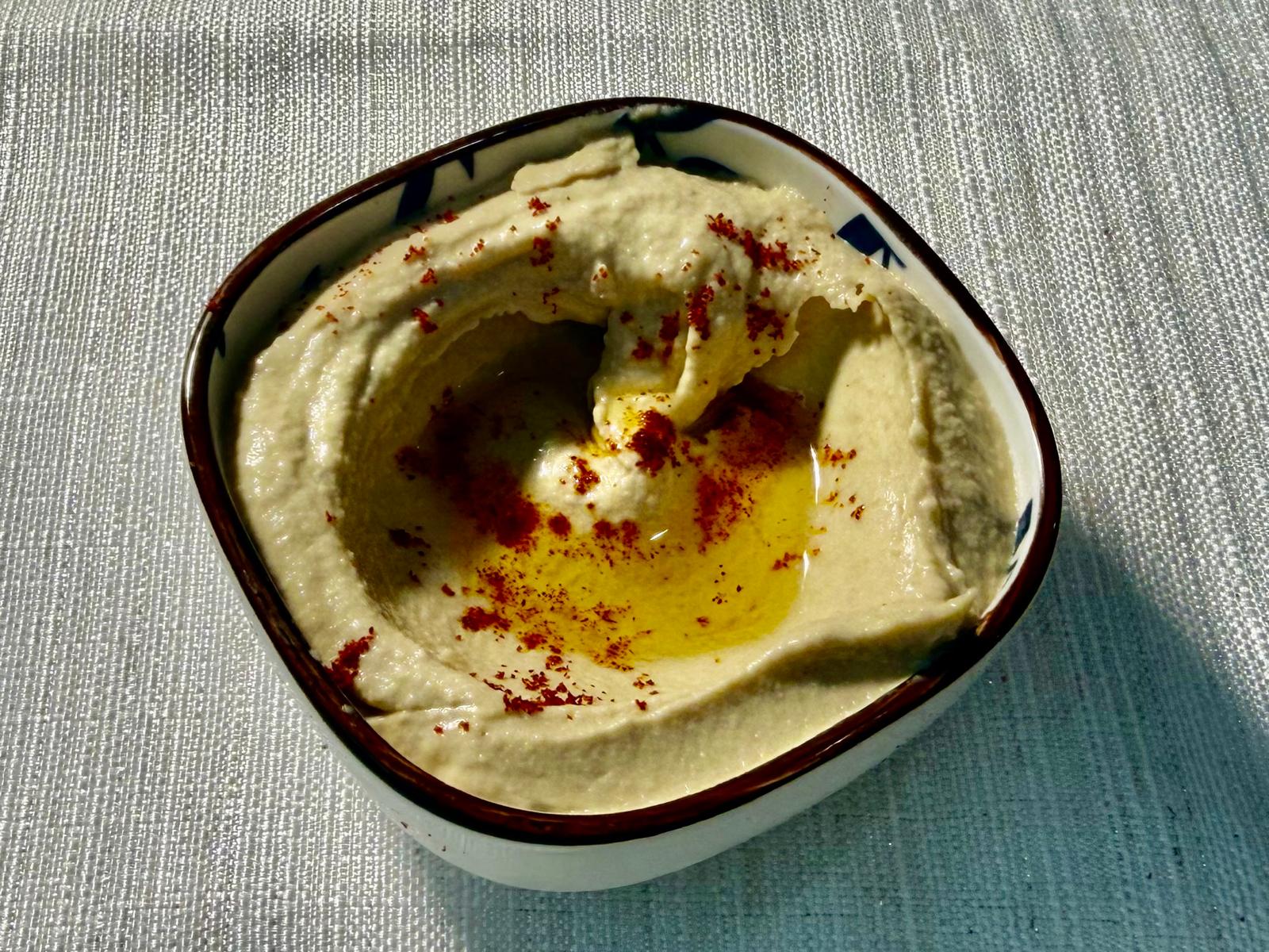 Creamy hummus drizzled with olive oil and paprika